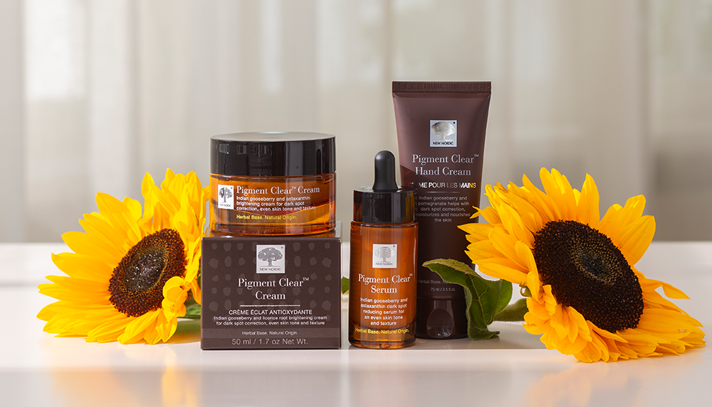 a group of our Pigment Clear products with sunflowers