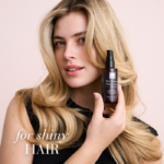 Woman with beautiful hair holding the Hair Volume™ Shine Serum with text For shiny hair.