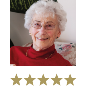 Active Legs⢠2 Image of a older woman smiling wearing glasses sat on her sofa with five stars beneath.
