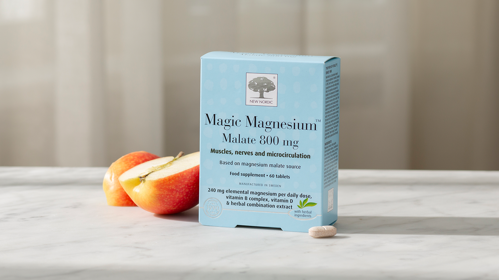 Transparent Testing 7 Magic Magnesium™ Malate with apples and a tablet on a light background.