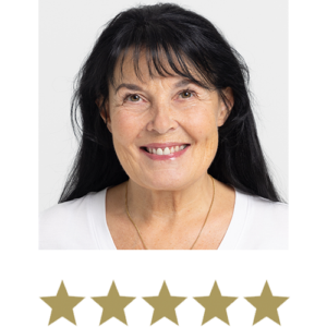 Natural Magic™ Anti-ageing Cream 2 Woman smiling with five stars displayed underneath.
