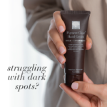 Hands holding Pigment Clear™ Hand Cream with the text ‘Struggling with dark spots?