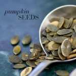 Pumpkin seeds on a spoon with the text Pumpkin seeds