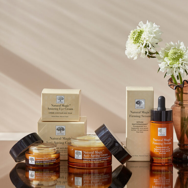 Natural magic range boxes and cream glasses. Next to it is a wase with white flowers