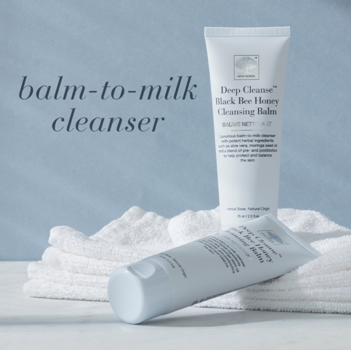 Light blue tube of Deep Cleanse™ Black Bee Honey Cleansing Balm with text Balm-to-milk cleanser